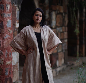 Woman wearing Ikat kimono shrug, tan color sewn by NGO in India